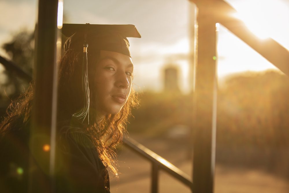 Epic graduation photo of Haven during sunset in Sioux Lookout, capturing a stunning moment of achievement.