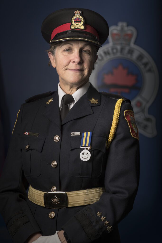 A female police officer posing for her retirement picture