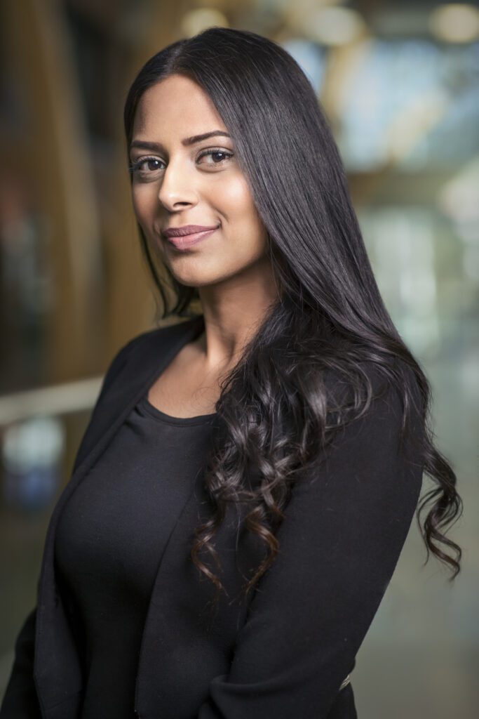 A young woman taking headshots and portraits in the halls of confederation college