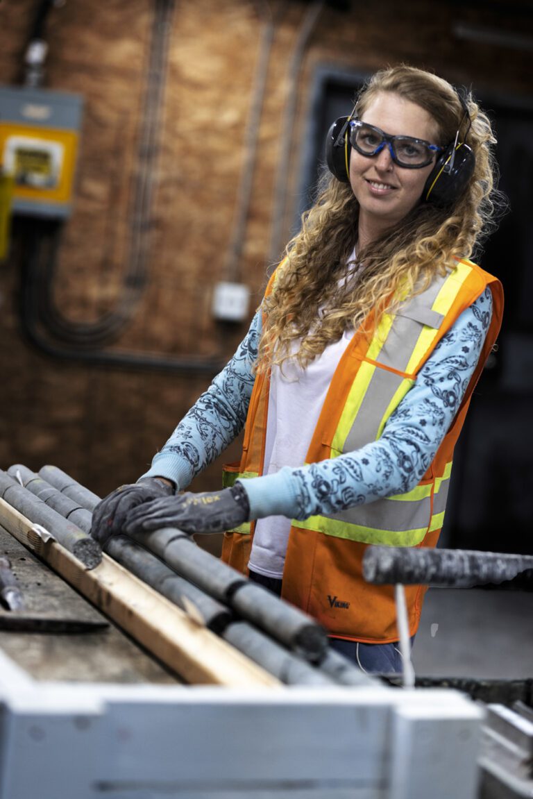 A young female geologist moving core samples around.