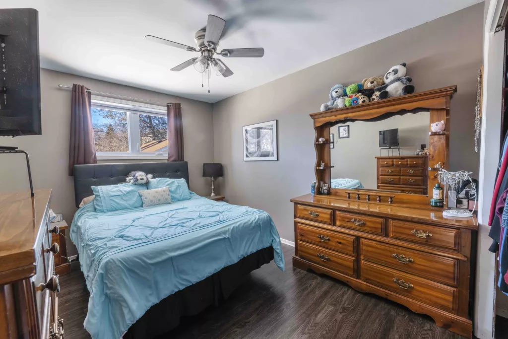 the masster bedroom in a thunder bay home that has been photographed in an HDR style