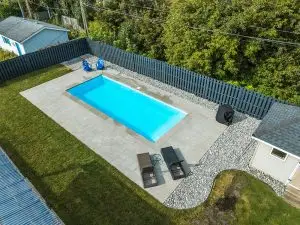 Side view video showcasing a beautiful backyard pool, filmed as part of a client testimonial for Pentarm Pools, highlighting their landscaping services.