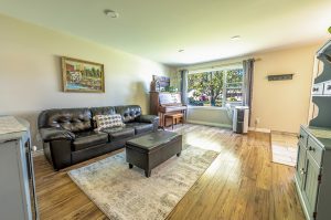 Bright living room with large window overlooking the front yard in a Thunder Bay home.
