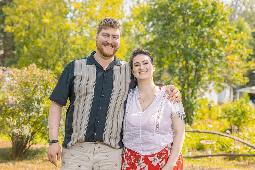 Norma’s grandson and his partner smiling together during a family portrait session in Thunder Bay.