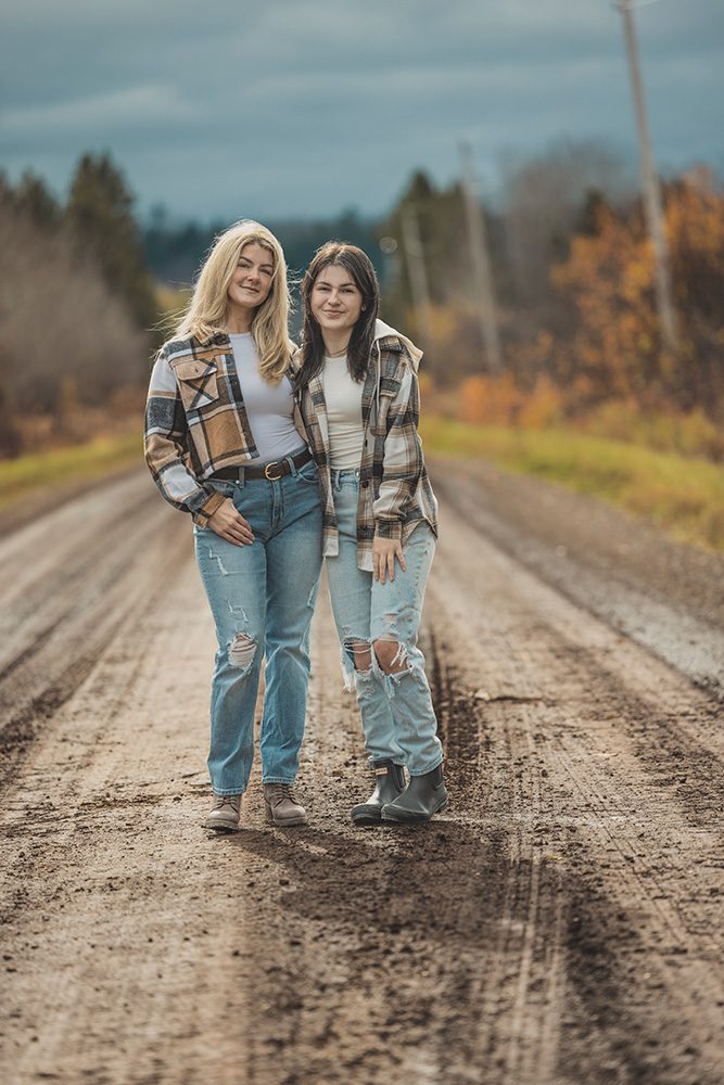 Jess and her daughter smiling together on a dirt road during a Professional family photo session professional family photo session