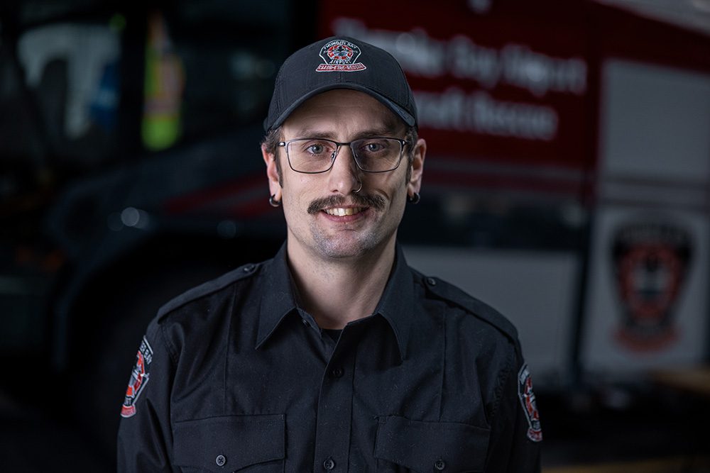 Corporate milestone photography casual portrait of airport operations graduate smiling