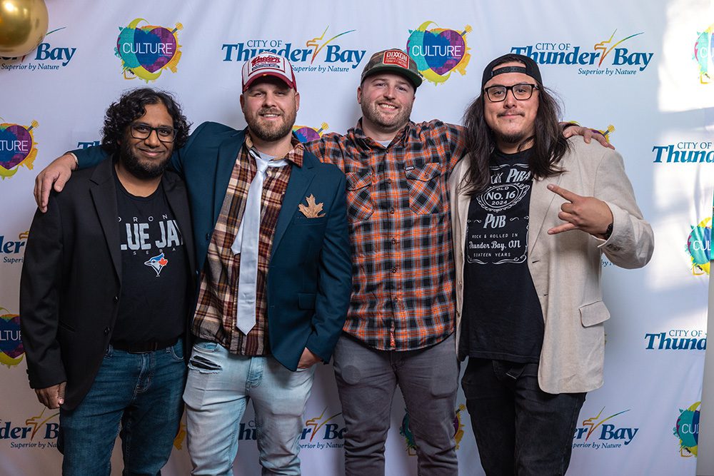 Four men in casual and formal attire posing together on the red carpet event photography Thunder Bay