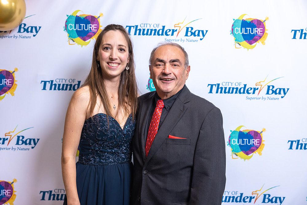 Couple in formal evening wear smiling on red carpet at Thunder Bay arts awards event