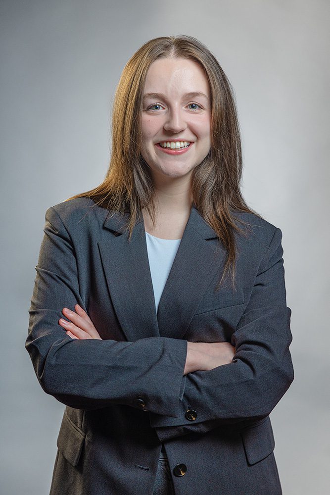 Professional medical student portrait arms crossed in business attire neutral background for one of her first Medical Student Headshots