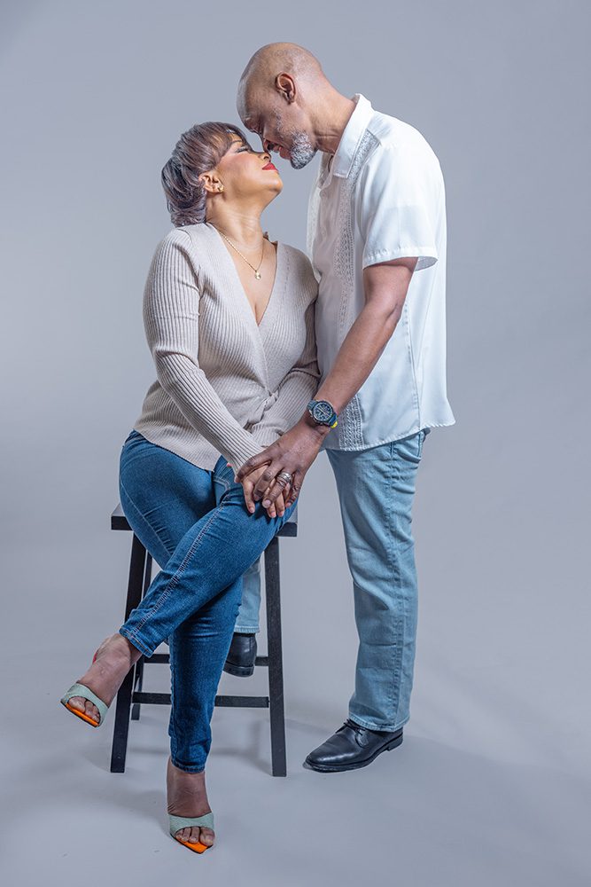 Couple touching foreheads during a timeless anniversary photoshoot in studio