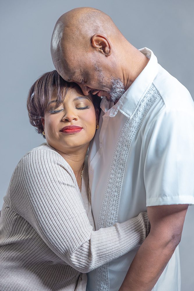 Couple embracing closely with eyes closed during an anniversary photoshoot