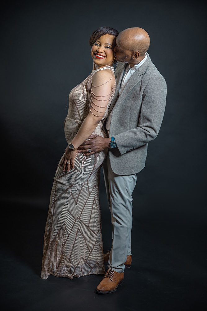 Couple posing together with coordinated outfits during a studio anniversary photoshoot