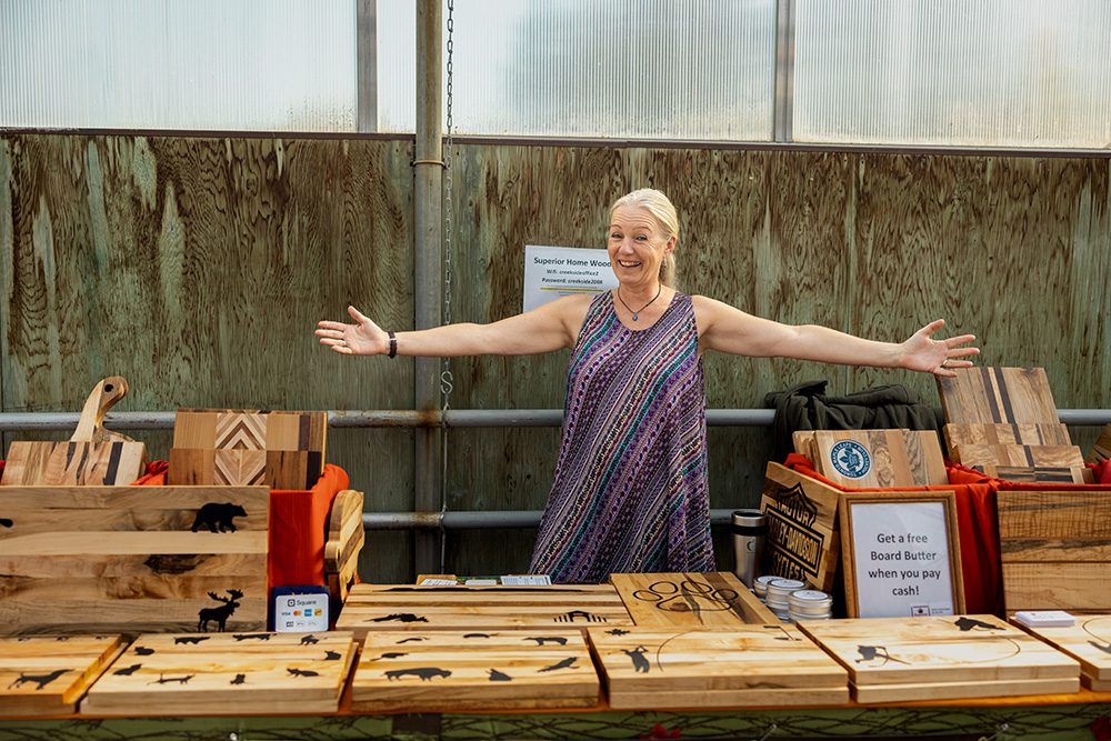 Small business advertising photos of woodworking craft vendor with handmade cutting board display