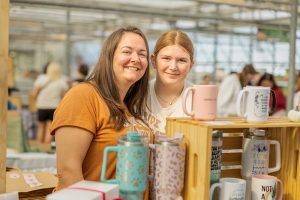Small business advertising photos of mother-daughter vendor team at craft fair booth