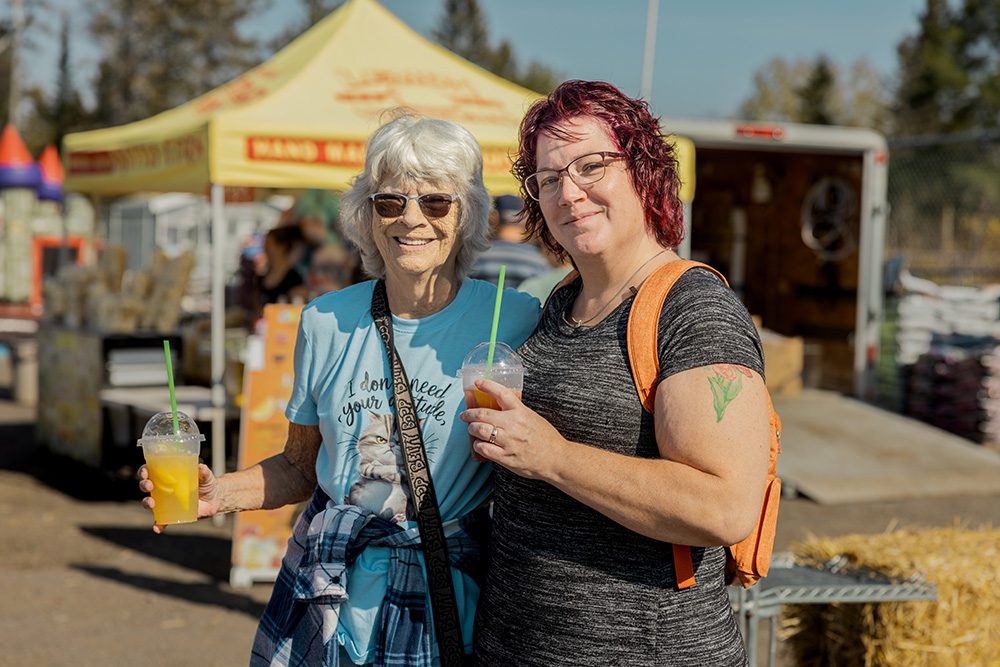 Small business event photography showing happy customers at outdoor craft fair with food truck vendors