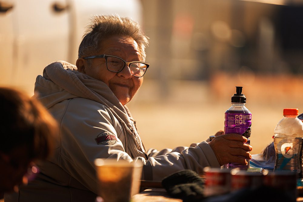 Elder seated at a table during the Moose Festival at North Caribou Lake