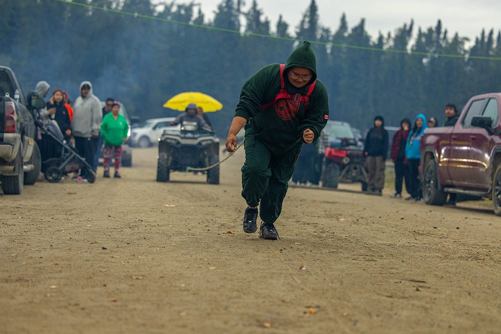 Community member participating in a game during the Moose Festival at North Caribou Lake