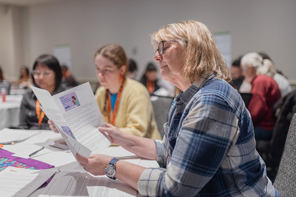 Woman reviewing conference program materials during education event