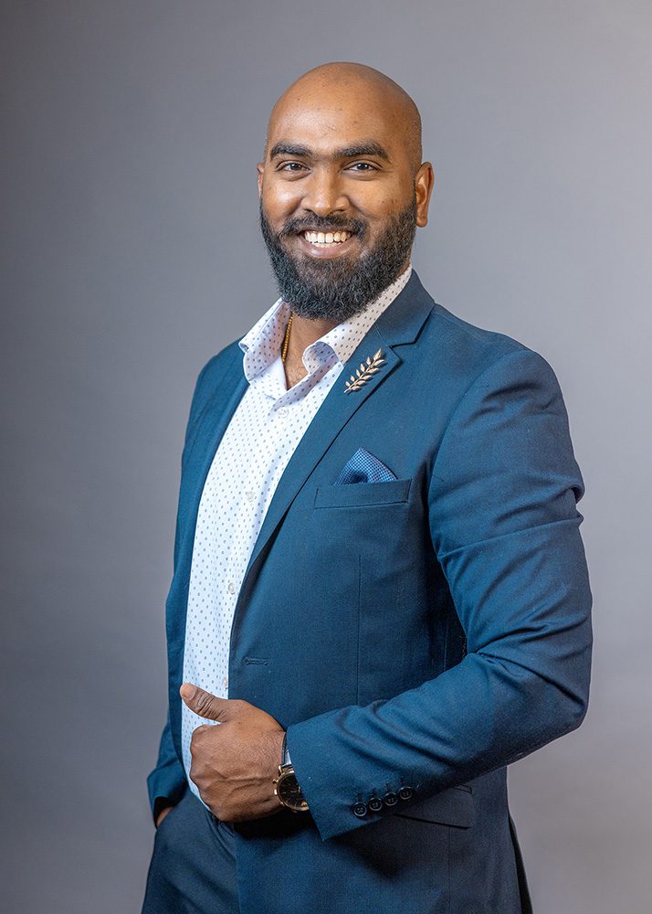 Professional headshot man smiling teal blazer approachable business photo