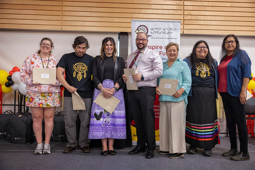 Group of graduates and presenters with awards at Thunder Bay graduation ceremony