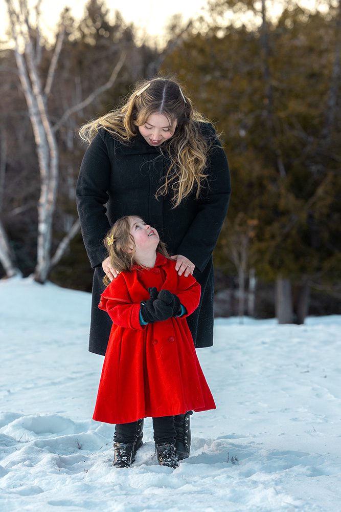 Mother gazing lovingly at daughter during quiet winter family photography moment