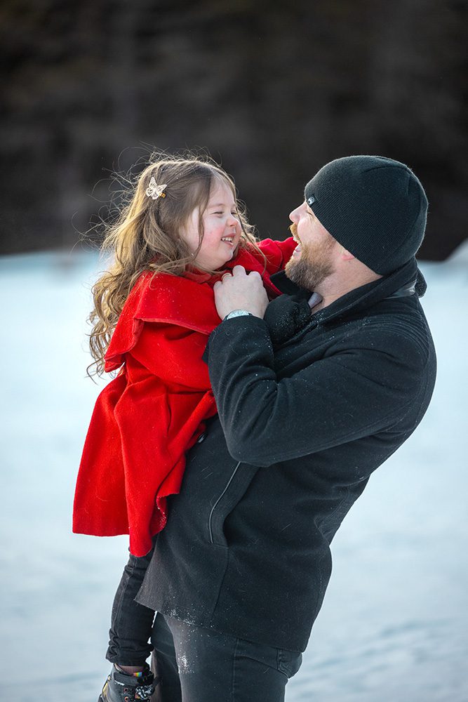 Intimate close-up of father and daughter during loving winter photography moment