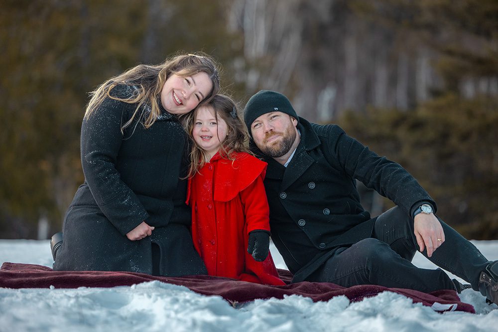 Relaxed family enjoying time together on blanket during winter photography session