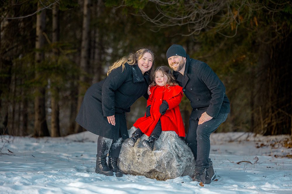 Playful family making silly faces together during fun winter photography session