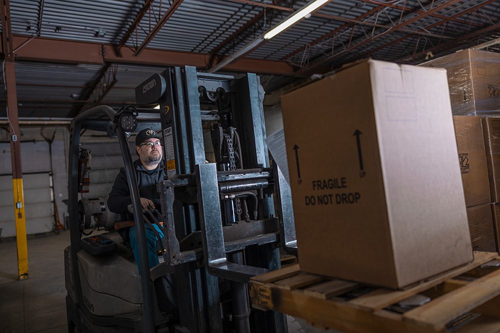 Forklift operator moving fragile cargo in Titan Transline warehouse