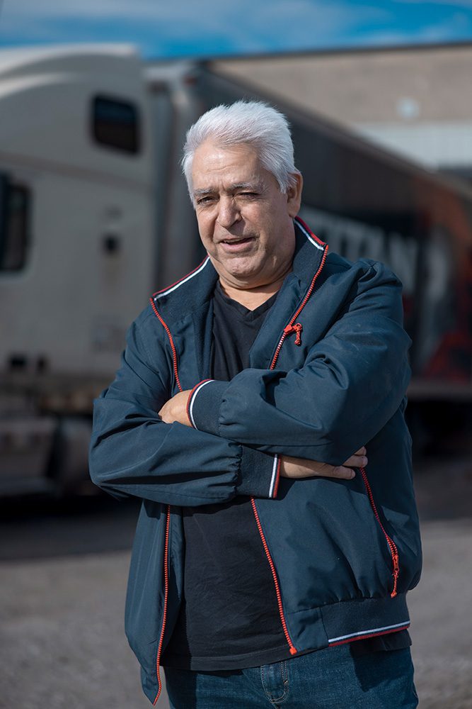 Professional headshot of senior Titan Transline employee with truck in background