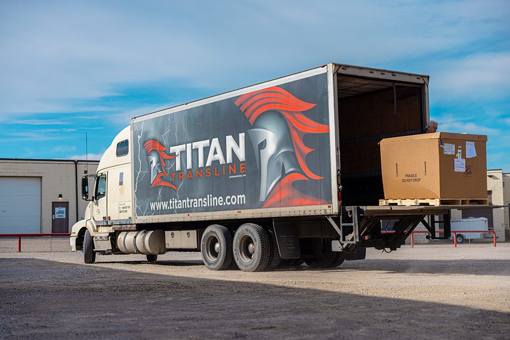 Titan Transline branded semi-truck trailer showing company logo and contact information