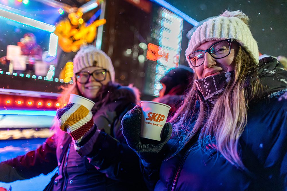 Event photography for brand activations capturing happy attendees with branded products at night event